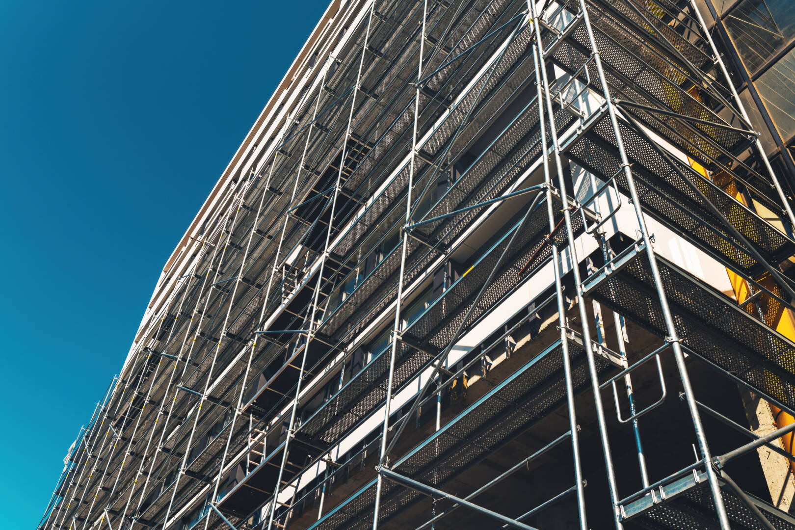 Construction site, scaffolding and building. Real estate develop